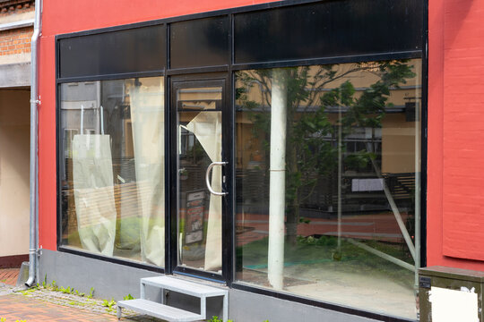 Vacant retail storefront with empty commercial space available for lease in urban shopping district