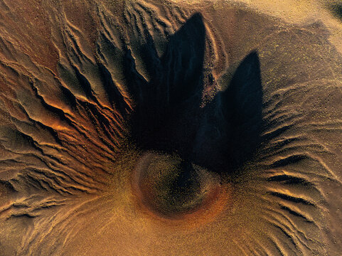Aerial view of volcanic cone and lava formations in Puna