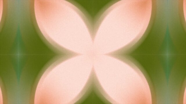 Abstract digital background with soft green and peach colored symmetrical floral shapes.