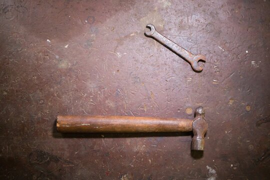 close-up of an old rusty wrench and hammer