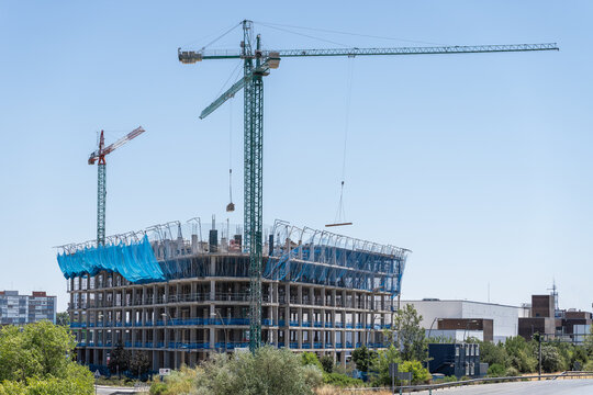 Tower crane above high rise building construction site