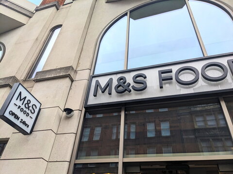 Modern exterior facade and signage of an M and S Food retail store on Charing Cross Road in London