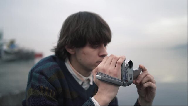Retro technology enthusiast, reviewing footage, handheld digital camcorder, Y2K nostalgia for tape media revival, vintage electronics, slow content and creative reuse.