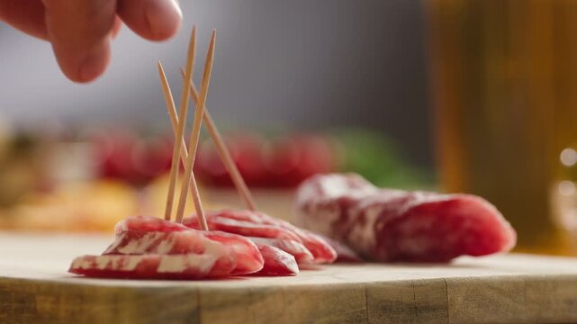 Mix of spanish pork sausages, Cutting board of appetizing catalonian snack - fuet, jamon, chorizo, olives, supermarket tapas food in spain, traditional cuisine. 