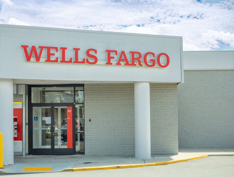 Wells Fargo bank branch entrance building exterior with large red text signage against a cloudy sky in Philadelphia, Pennsylvania, USA, August 2, 2026