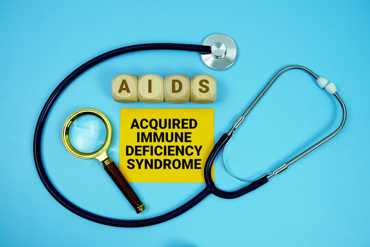 Acquired Immunodeficiency Syndrome (AIDS) text with stethoscope and magnifying glass on blue background