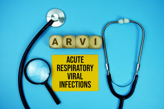 Acute Respiratory Viral Infections (ARVI) text with stethoscope and magnifying glass on blue background