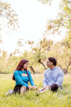 Latino man with prosthetic legs sitting with woman