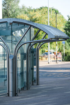 Modern glass bus stop shelter on urban street in England
