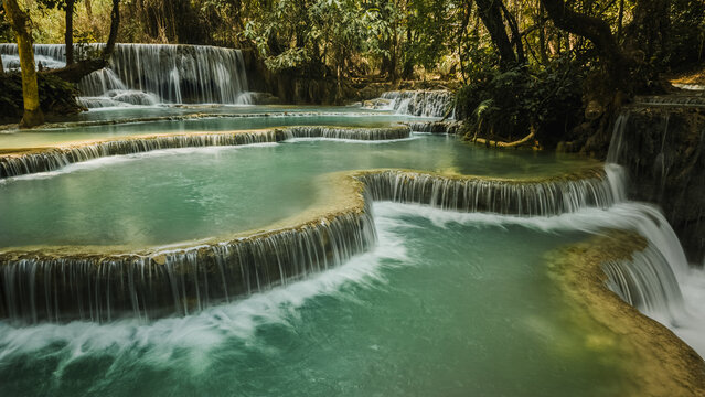 Kuang Si Waterfall cascades through lush forest in Laos