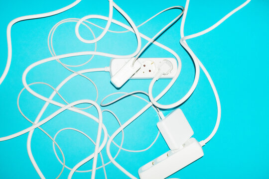 White cable coil and connector on turquoise background