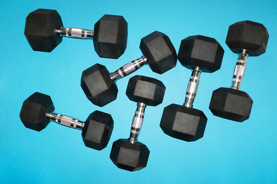Hex dumbbell set on blue background for gym workout