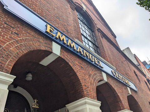 Low angle view of the historic red brick facade of the Emmanuel Centre in Westminster, London