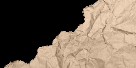 Fototapeta premium Crumpled kraft paper texture, torn brown paper edge on black background