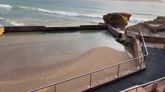 Ocean Pool at Sunrise with Gentle Waves and Coastal Rock Formation, NSW Australia