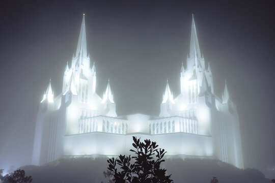 A striking image of an imposing, fog-covered structure with grand spires, evoking a sense of mystery and awe, set in an atmospheric landscape.
