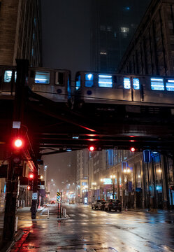 A classic train moving seamlessly above a bustling city, surrounded by fog; this composition captures the movement and spirit of urban transportation in twilight.