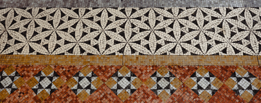 A stunning close-up of an intricate mosaic pattern on the floor of a historic building, showcasing beautiful designs that reflect artistry and the importance of detailed craftsmanship.