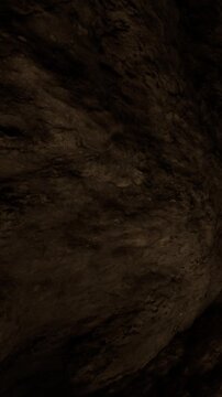 A close view of a cave wall shows rough and textured surfaces. The lighting highlights the details of the stone. The scene suggests exploration in an underground environment.
