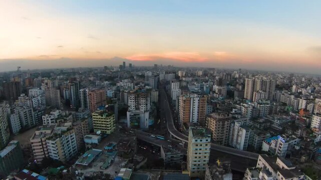 Aerial Drone Shot of Mouchak Moghbazar Flyover and Dhaka City Skyline at Sunset, Bangladesh