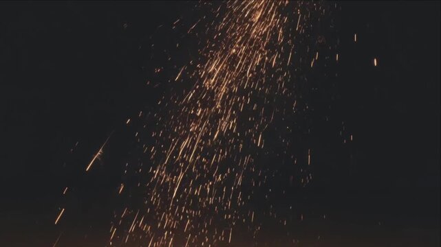 Cinematic macro fire spark ember flame trail over dark night background abstract motion light streak pattern creating dynamic festive energy texture surface with glowing sparks cinematic macro texture