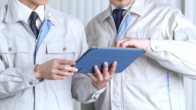 タブレットを使って現地調査をする作業員