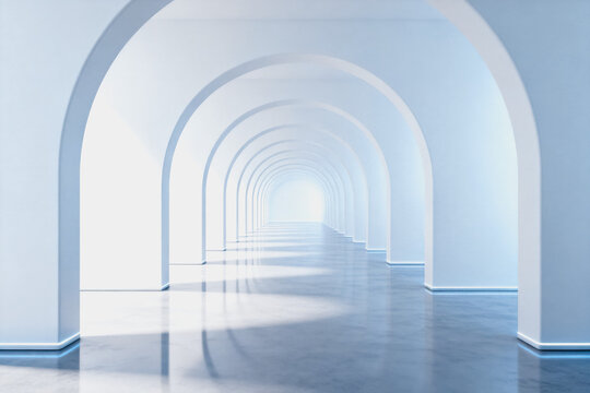 A long, empty arched corridor in a bright, minimalist modern indoor space with smooth reflective floors.