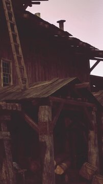 A wooden building stands with a ladder leaning against its side. There is a person working on the roof. Nearby logs are stacked. The scene shows rural life and construction work.