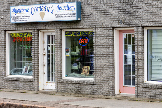 Campbellton, New Brunswick, 06 June 2026 : Bijouterie Comeau's Jewellery storefront features signs for watch and jewellery repair and gold buying.