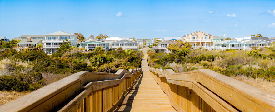 Wooden boardwalk leads to beach houses in South Carolina
