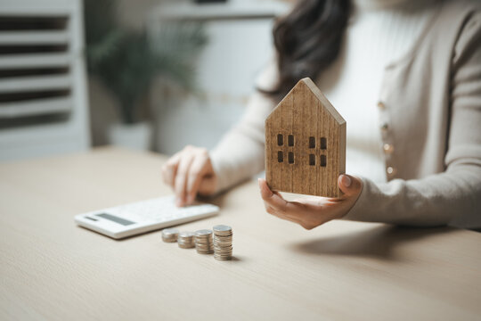 home savings, mortgage planning, and wooden house shape this practical household finance scene. It conveys practical choices, organized planning, everyday money management, and financial awareness.