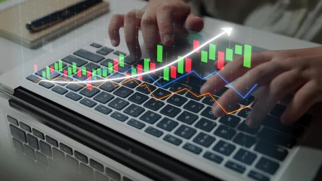 Close-up of hands typing on a laptop keyboard while analyzing financial data on a digital chart. Ideal for illustrating business growth and investment strategies. Copula