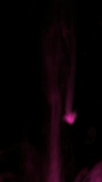 Glowing pink energy trail against black background