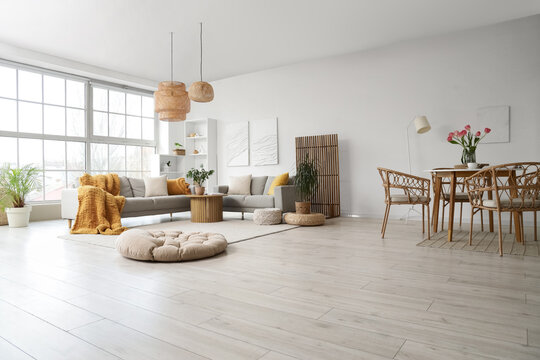 Interior of modern studio apartment with sofas and dining table