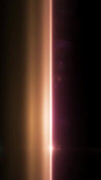 Vertical pink and orange anamorphic lens flares on black background