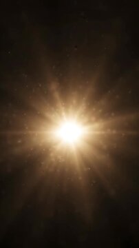 Golden starburst lens flare effect on black background