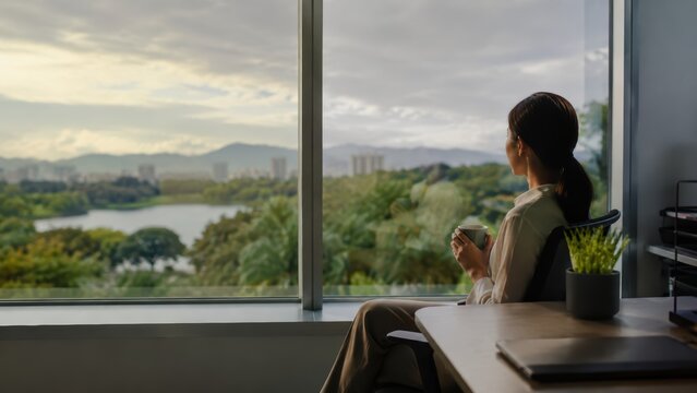 Businesswoman Looking Through Window for Longevity Vision Office Photo