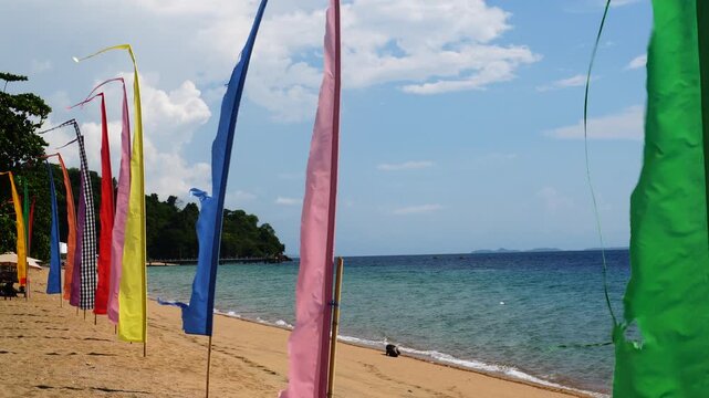 Colorful traditional flags fluttering on sandy tropical beach