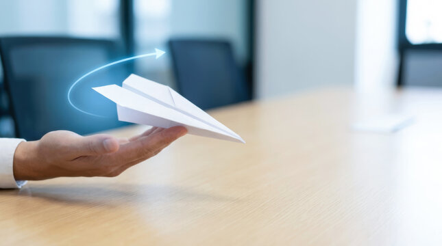 Paper plane hand office table launch action plan flight concept