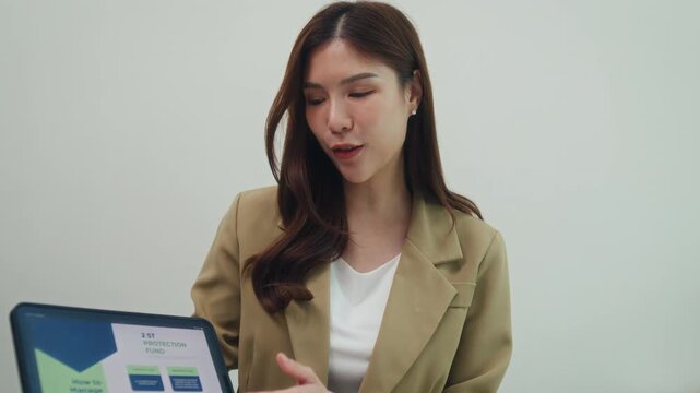 Close up finance advisor explain investment show tablet report to young asian couple. Financial investment consultation, insurance plan guidance, house mortgage loan contract, banking advice concept.