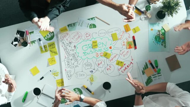 Top view of professional business team hands working together to brainstorm environmental idea by using mind map and clapping hands. Aerial view of smart manager talking and discussing. Alimentation.