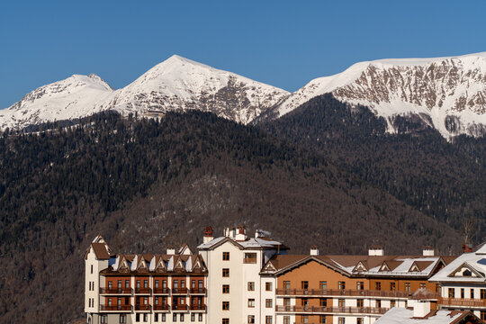 Mountains, RosaKhutor, Sochi: Winter Snowcapped Peaks above Resort Buildings.