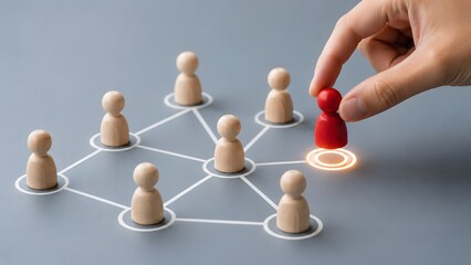 Obraz premium Hand connecting unique red figure into corporate networking structure