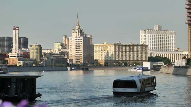 Moscow cityscape with Government House, Moskva River, and modern electric riverboat