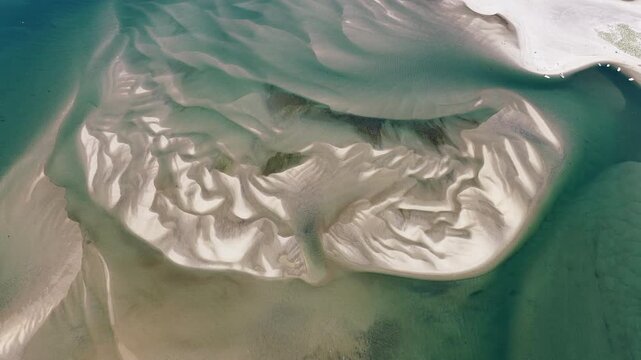 Currents from the Atlantic Ocean continuously shape the sand bars and scenic beaches of Cape Cod, Massachusetts. The entire peninsula is in constant movement due to its geologic makeup of mostly sand.