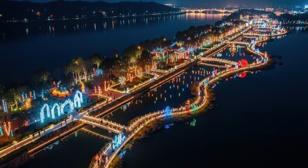 Fototapeta premium Illuminated Lantern Festival Along Winding Riverbanks at Night, Showcasing a Vibrant City Celebration