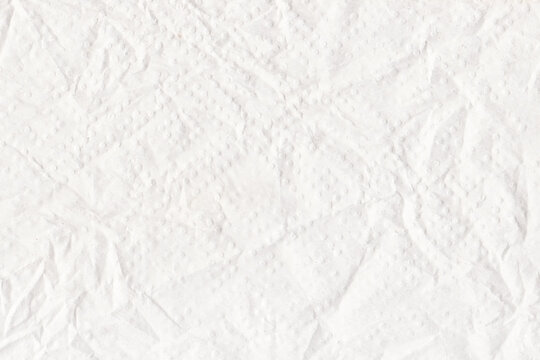 White crumpled tissue paper texture background with soft embossed pattern and wrinkled surface
