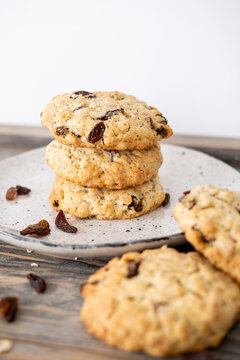 Oatmeal treat. Rustic food. Traditional crispy sweets pile served on plate. Healthy oat raisins cookies on table background free space.