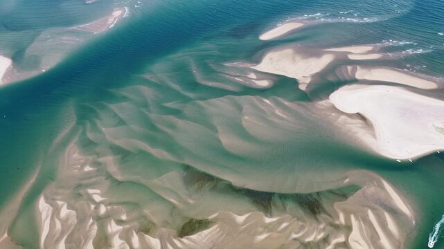 Currents from the Atlantic Ocean continuously shape the sand bars and scenic beaches of Cape Cod, Massachusetts. The entire peninsula is in constant movement due to its geologic makeup of mostly sand.