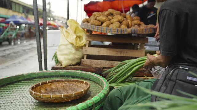 Vendor Tying Green Onion Bundles for Display at Local Market